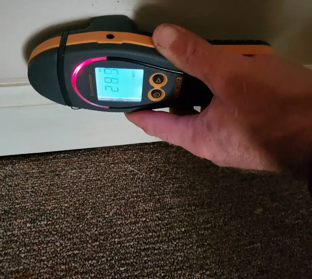 Moisture detection at baseboard during Storm Damage Restoration in Derby